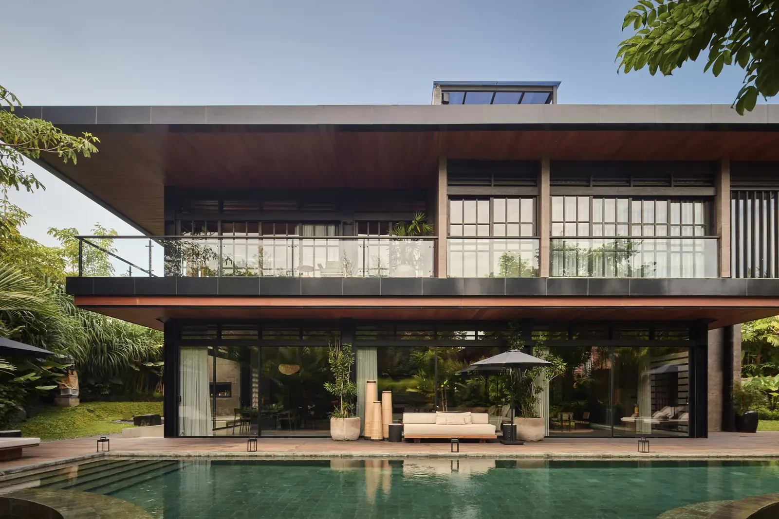 Exterior view of Villa Suki, showcasing its rotated square design and surrounding gardens.