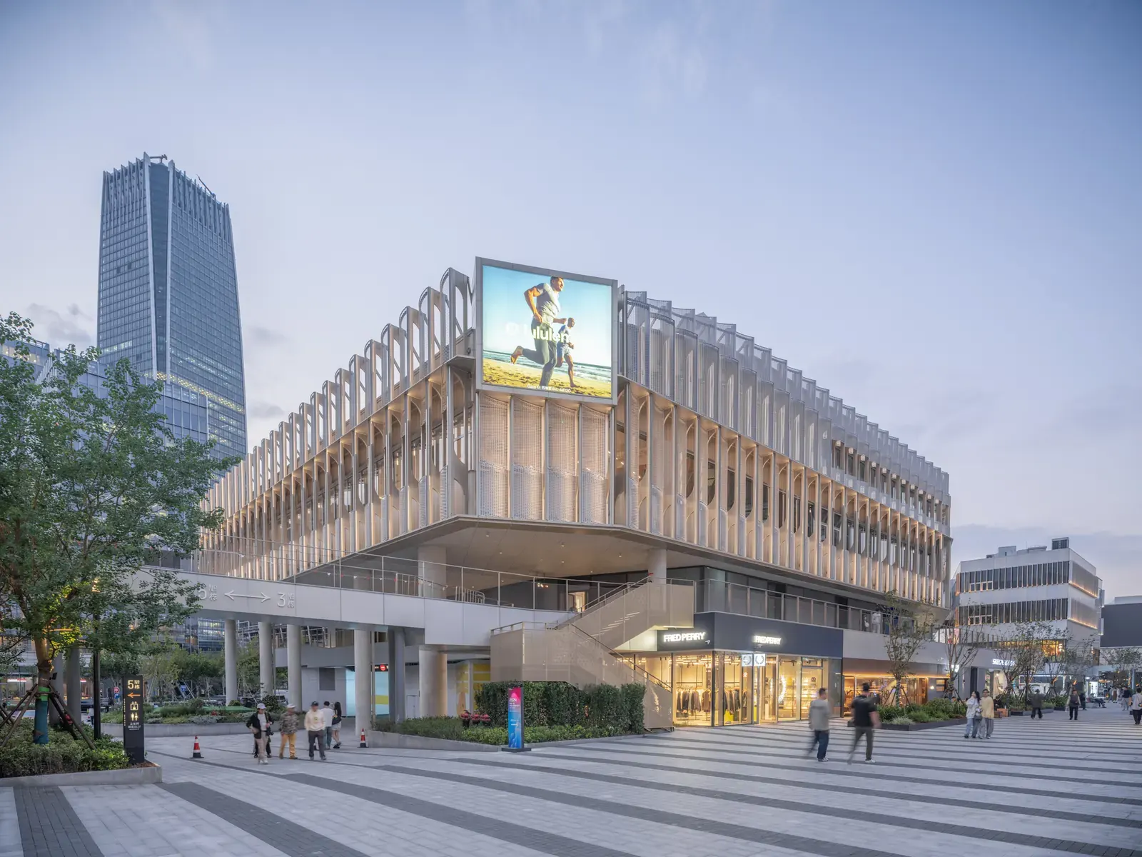 Exterior view of buildings 1 and 3 at the West Bund Dream Center, designed by HCCH Studio, showcasing modern architectural elements against a waterfront backdrop.