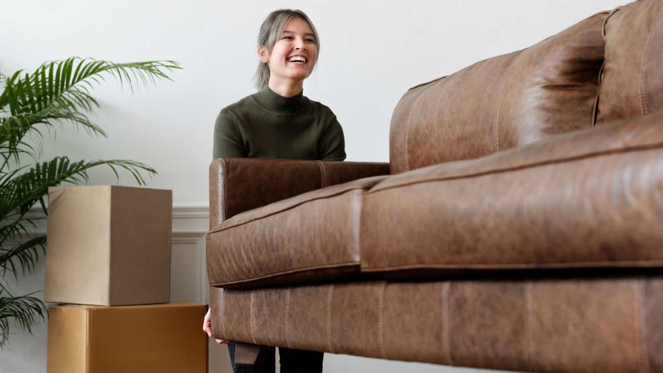 A modern, compact living room in Singapore featuring stylish, space-saving furniture like a sofa bed and a foldable coffee table.