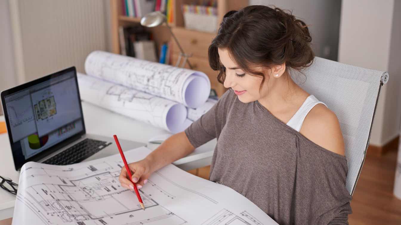 Architecture student working on a physical scale model in a design studio