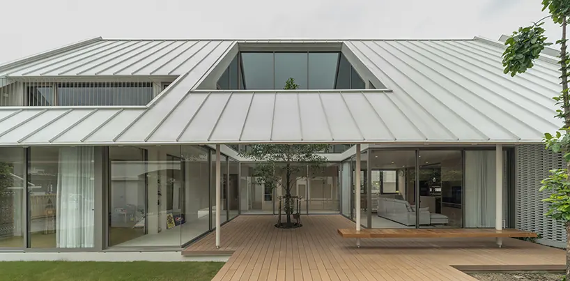 Bhoon+ House in Bangkok centers family life around a planted courtyard