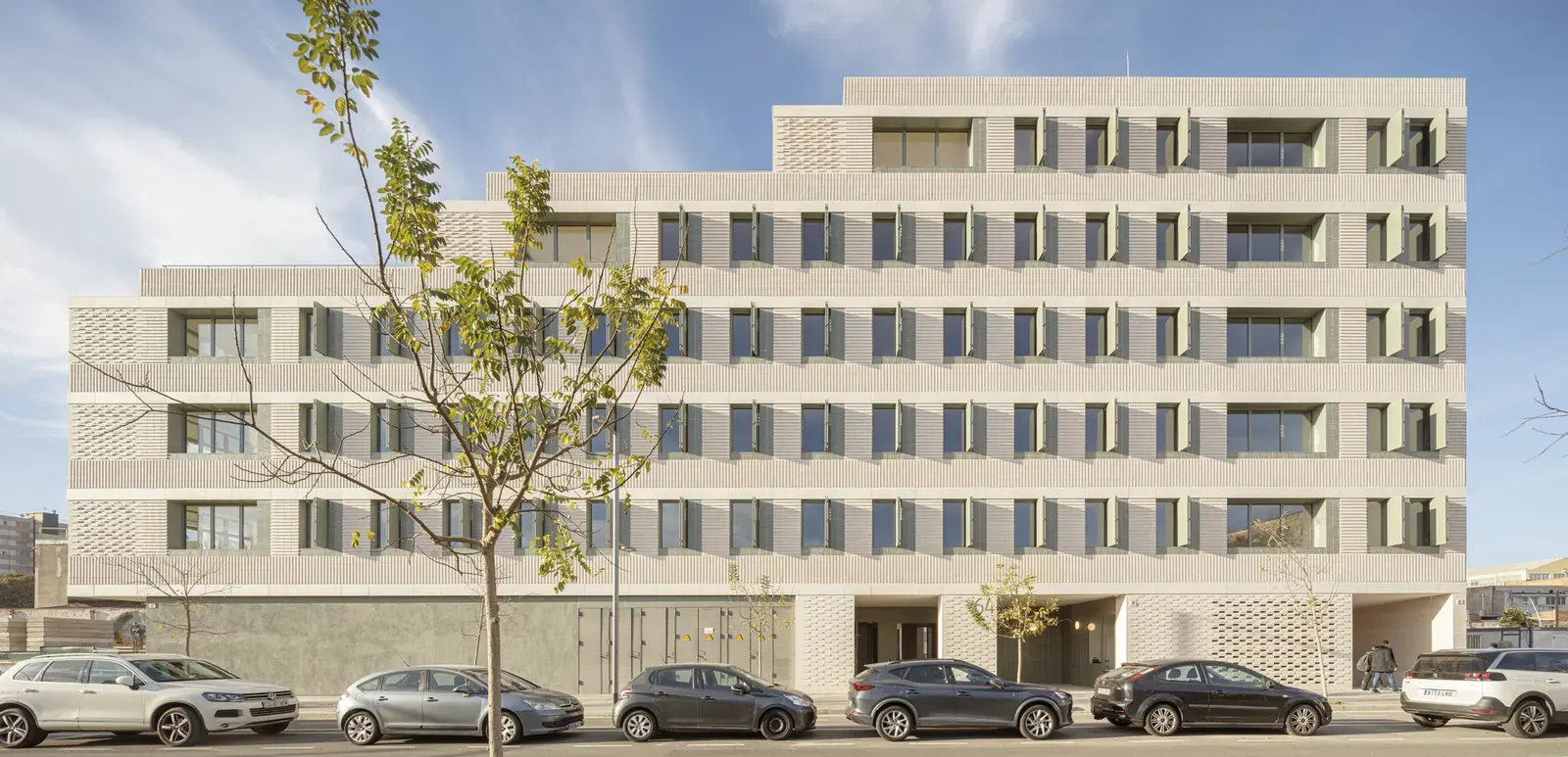 Newly completed 37-dwelling build-to-rent building in L’Hospitalet de Llobregat by b720 Fermín Vázquez Arquitectos, featuring a rational facade design with balconies and a