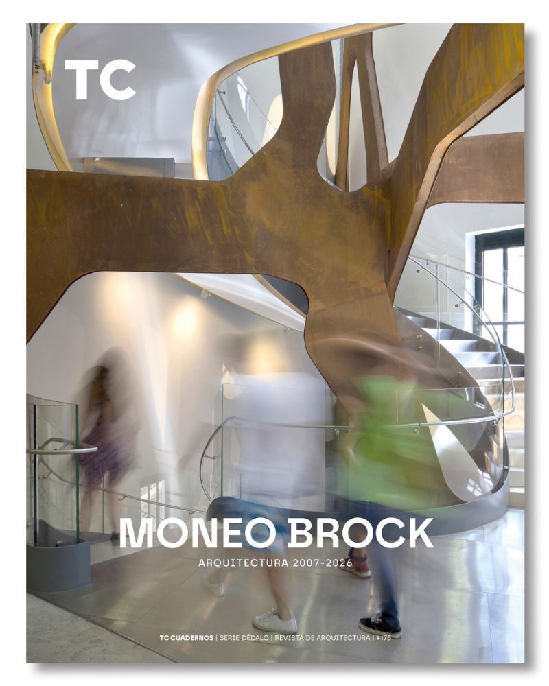 Moneo Brock building facade featuring coral stone masonry and geometric lattice screen, Mediterranean landscape visible in background