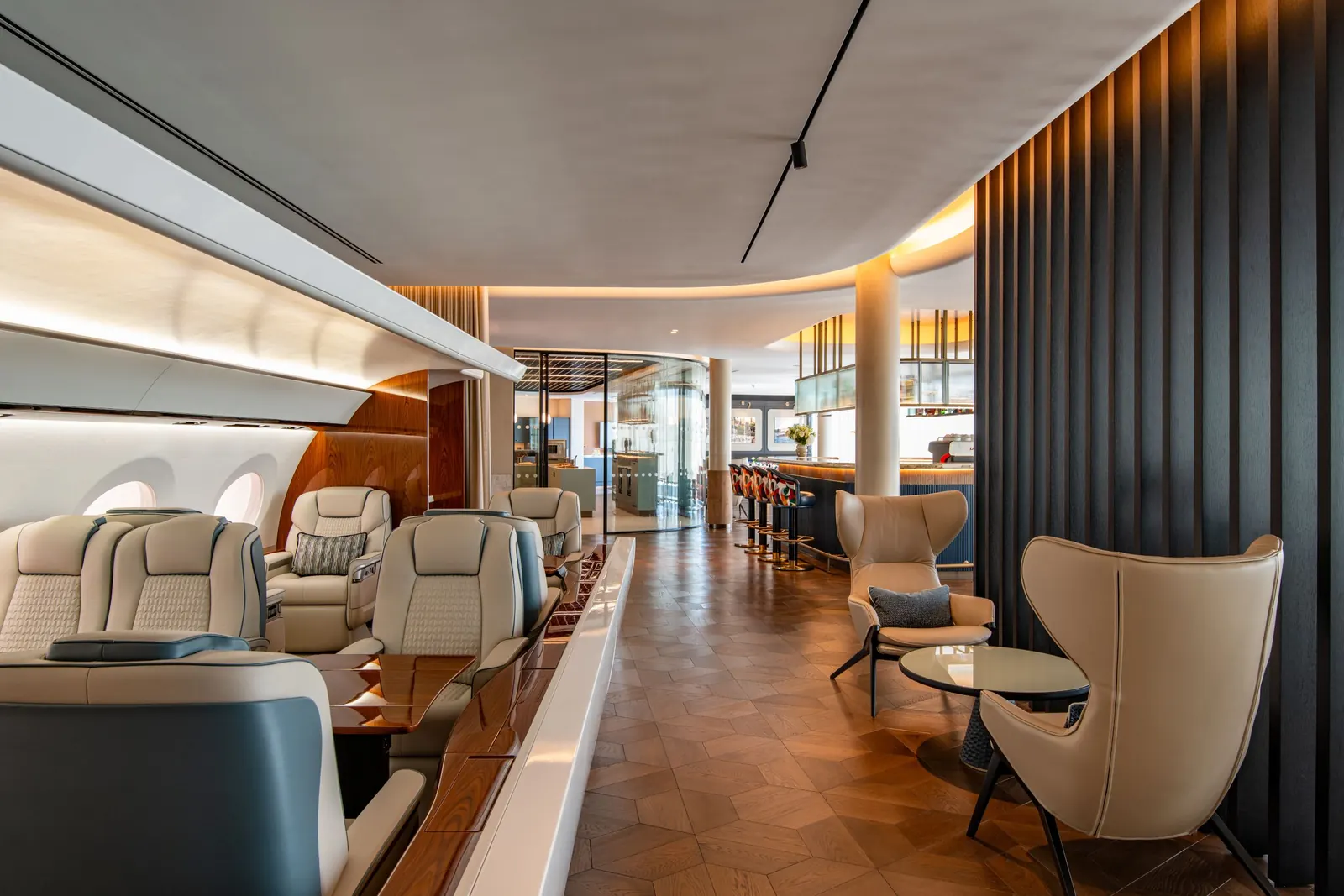 Flexjet private terminal at Farnborough Airport interior with oval bar, curved walls and warm-toned furnishings